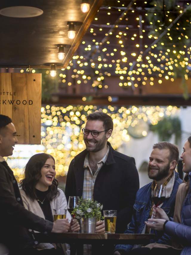 Group of people mingling at bar