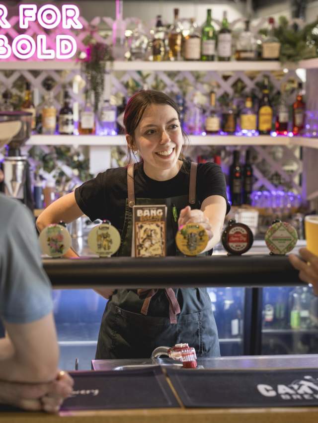 People ordering beer at a bar