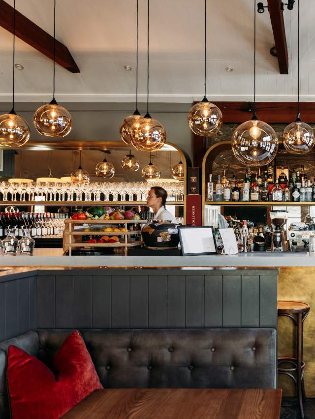 Interior shot of Aosta Restaurant - modern design with liquor bottles in the background