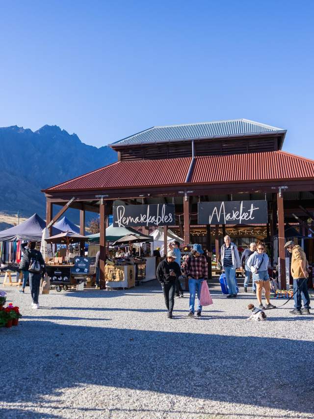 A landscape shot of the iconic Remarkables Market Red Barn on a Saturday morning