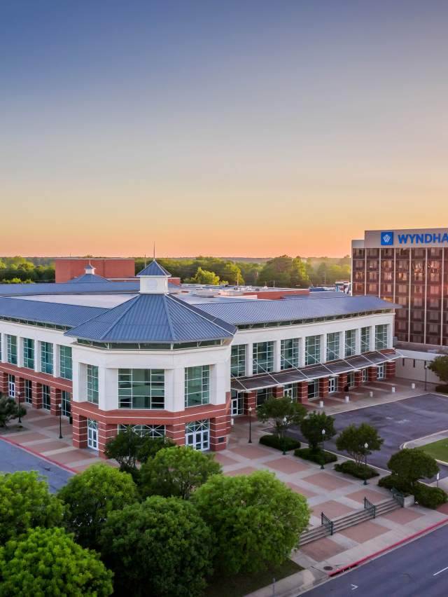 The sun sets behind the convention center in Fort Smith, Arkansas.