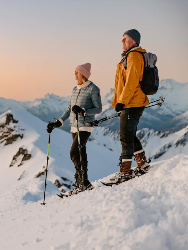 Couple snow shoeing at sunset on Mt Larkins near Glenorchy