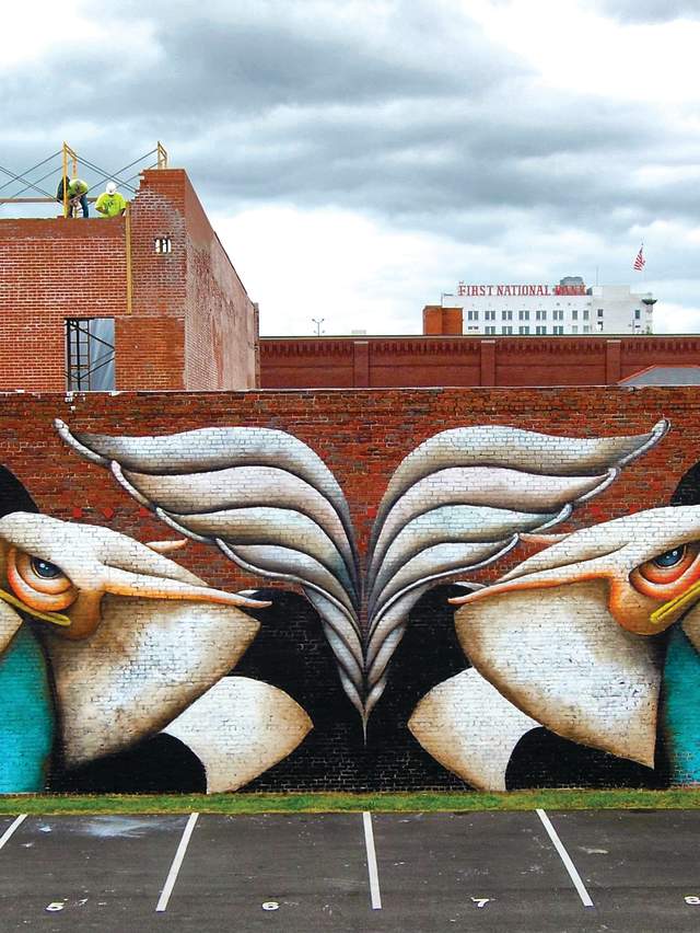 A colorful mural of birds covers a brick building in downtown Fort Smith.