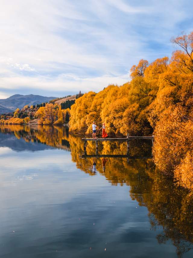 People on a pier at Lake Hayes in Autumn