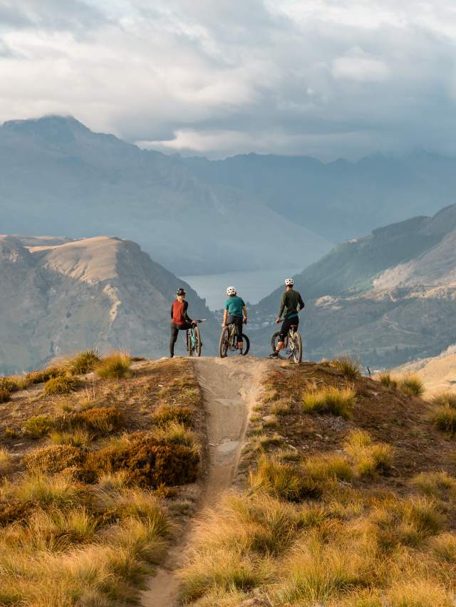Riders overlooking Queenstown at Rude Rock, Coronet Peak