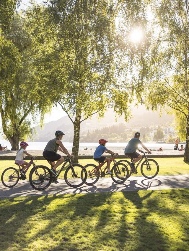 Family biking along Queenstown waterfront