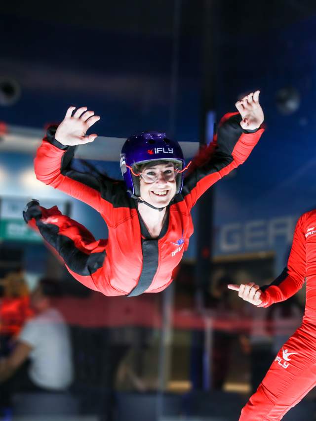 Lady flying next to instructor at iFly