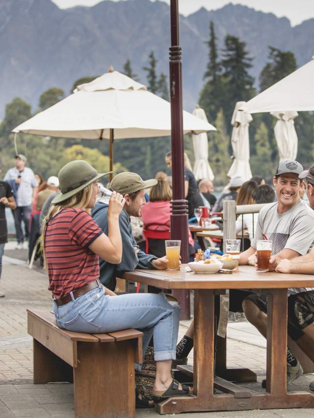 Group of friends enjoying Mountain Biking Apres outside at Atlas Bar