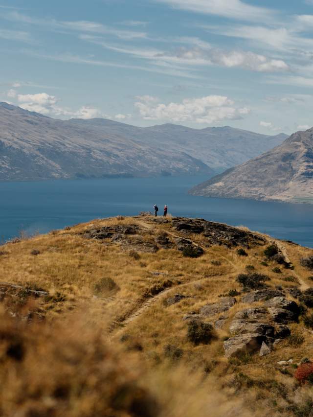 A couple look out towards Lake Whakatipu from Queenstown Hill