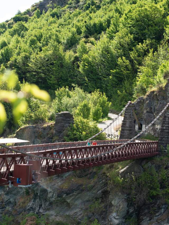 Bikers travelling over the Kawarau Suspension Bridge