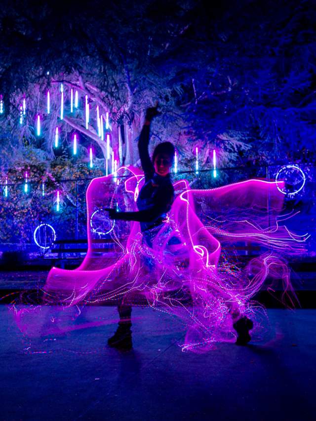 Person in a light up costume at night