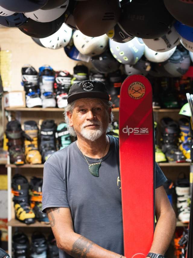 Portrait of Darryl Tatom, Owner of Small Planet in shop surrounded by winter sports gear