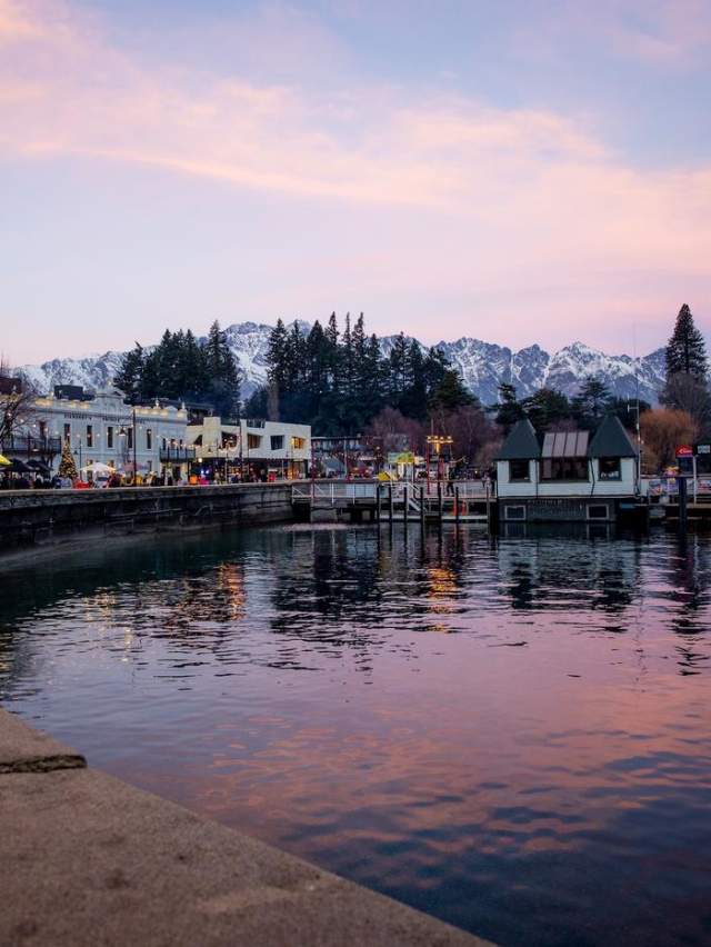 Queenstown waterfront in winter at sunset with the Remarkables mountain range covered in snow