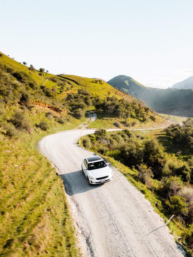 EV driving to Moke Lake with mountains in the background