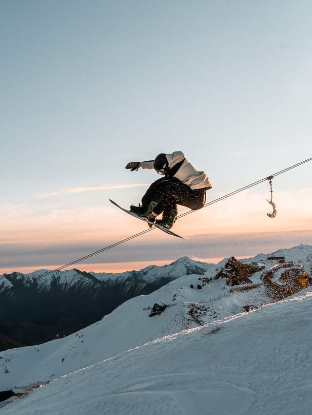 Snowboarder doing a trick at Coronet Peak at Sunset