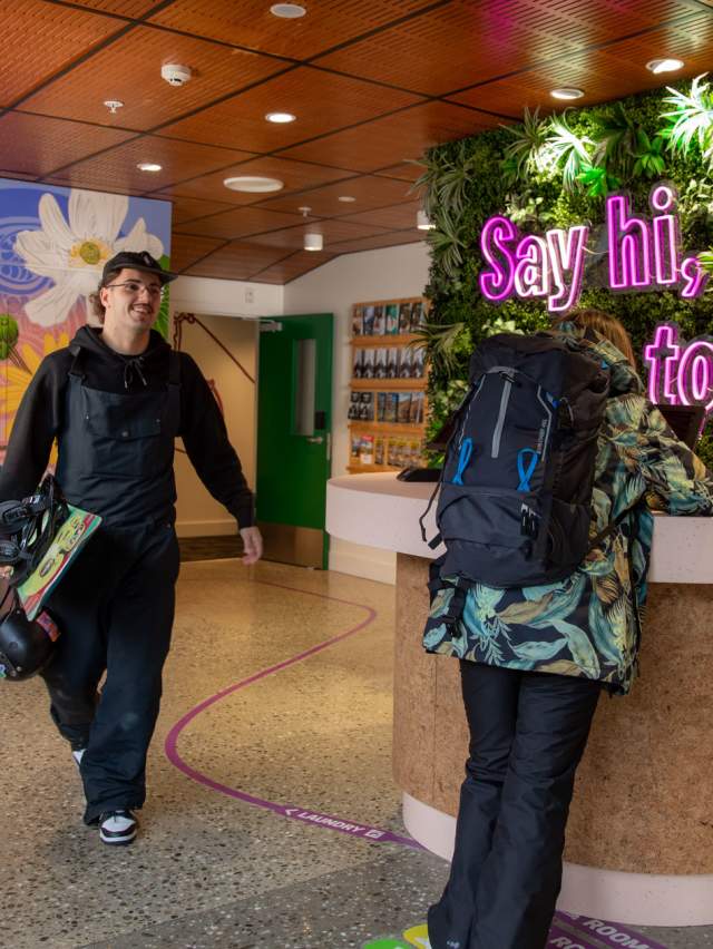 People in a colourful funky hostel