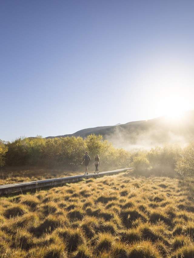Two people walking the Glenorchy Lagoon Walkway in the morning