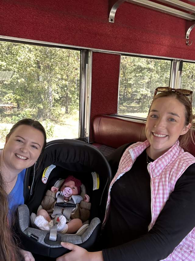 Three girls and a baby enjoy a train ride at the Heart of Dixie Railroad Museum.
