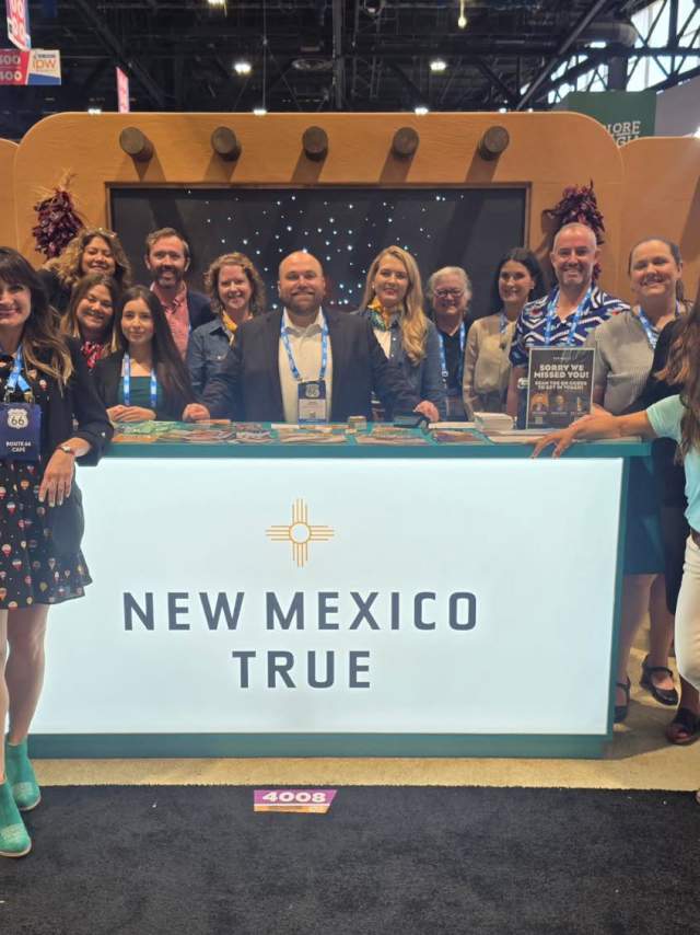 Group of people at check in desk for New Mexico tradeshow booth