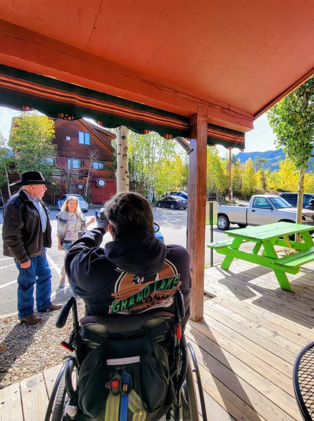 Man in wheelchair taking pictures on the boardwalk