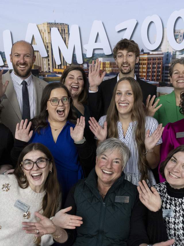 The Discover Kalamazoo Team excitedly throws out their arms to welcome you to Kalamazoo County, MI.