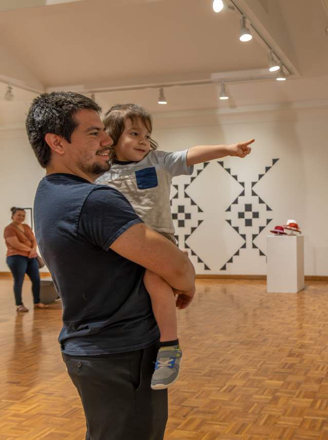 Father and son looking at paintings at Salina Art Center