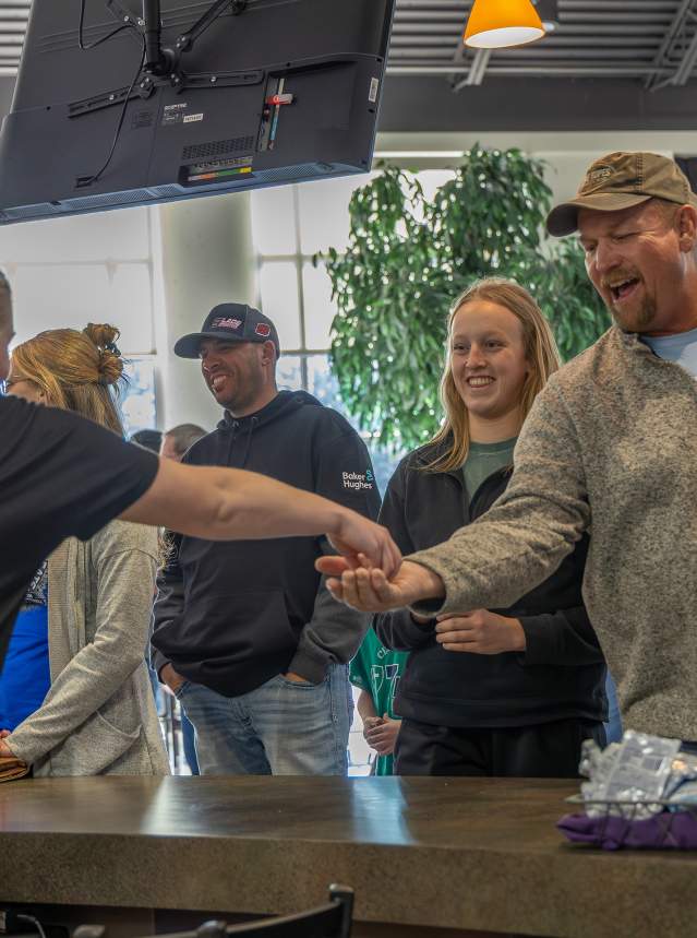 A customer getting change at Concession stand at KSHAA State Basketball Tournament in Salina, Kansas