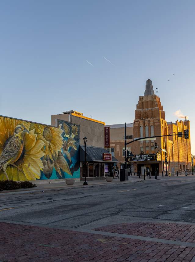 Picture of downtown with mural of a meadowlark by Curtis Hylton as park of the BOOM! Salina festival. The Stiefel Theatre is visible in the background, in Salina Kansas