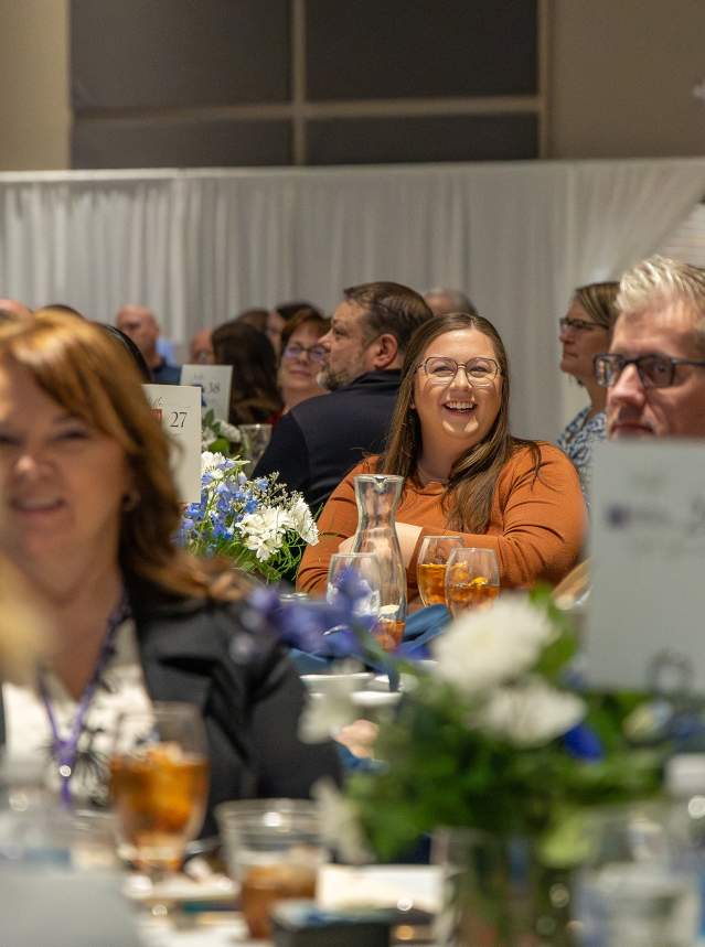 Crowd of people smiling at Annual Meeting 2026 in Tony's Pizza Event Center. Located in Salina, Kansas