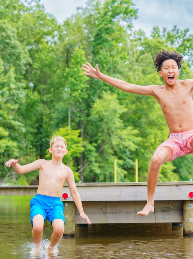 Two Boys Jumping Off a Pier at Cypress Black Bayou