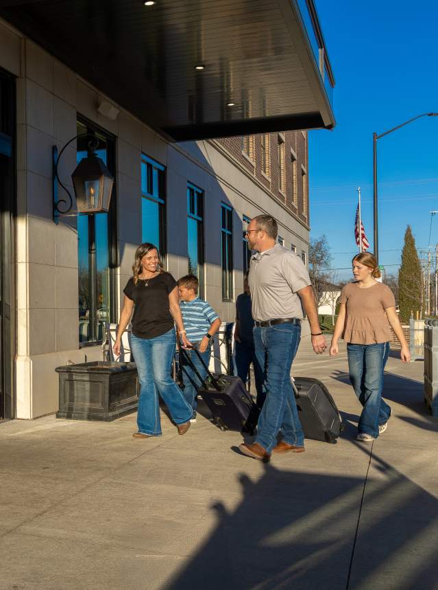 A family enters the Homewood Suites hotel