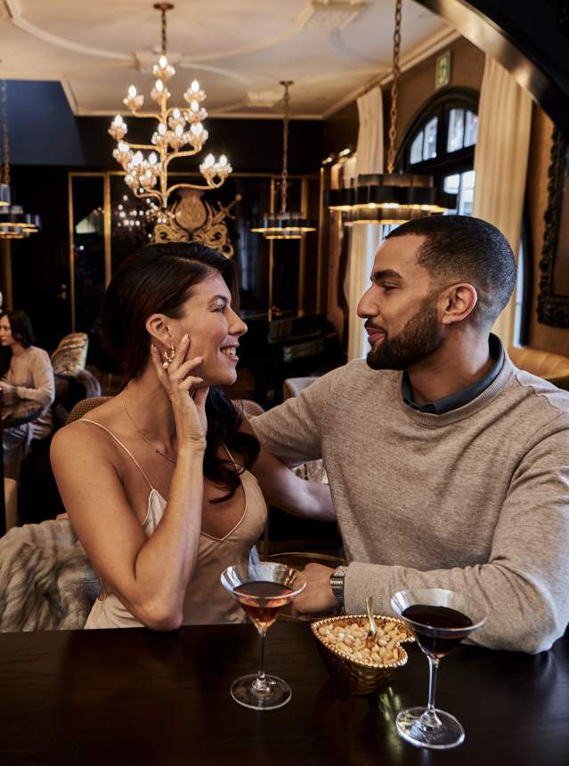 Couple sharing drinks at an eclectic hotel bar