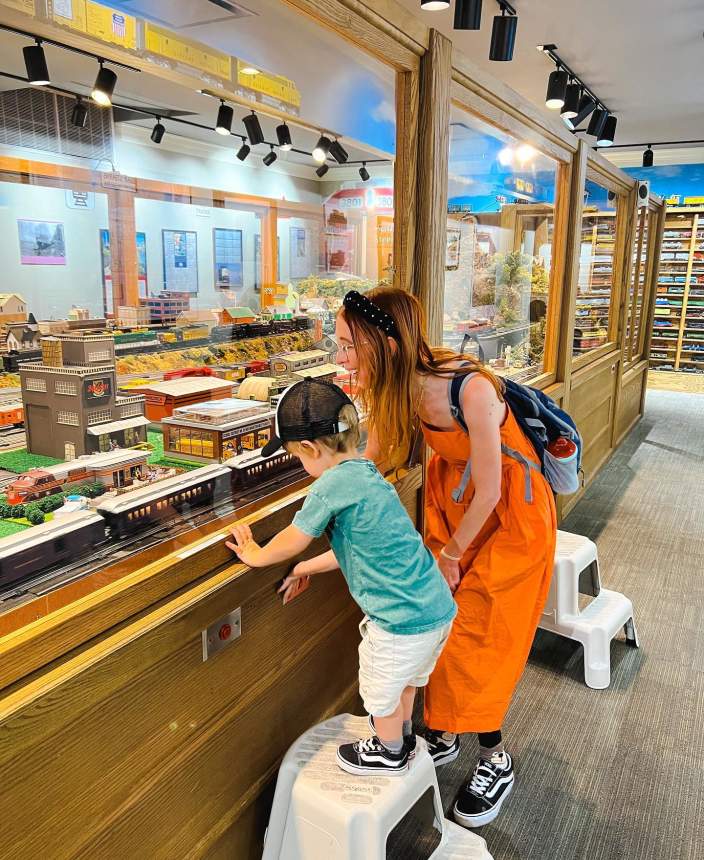 Mom and son looking a large model train display