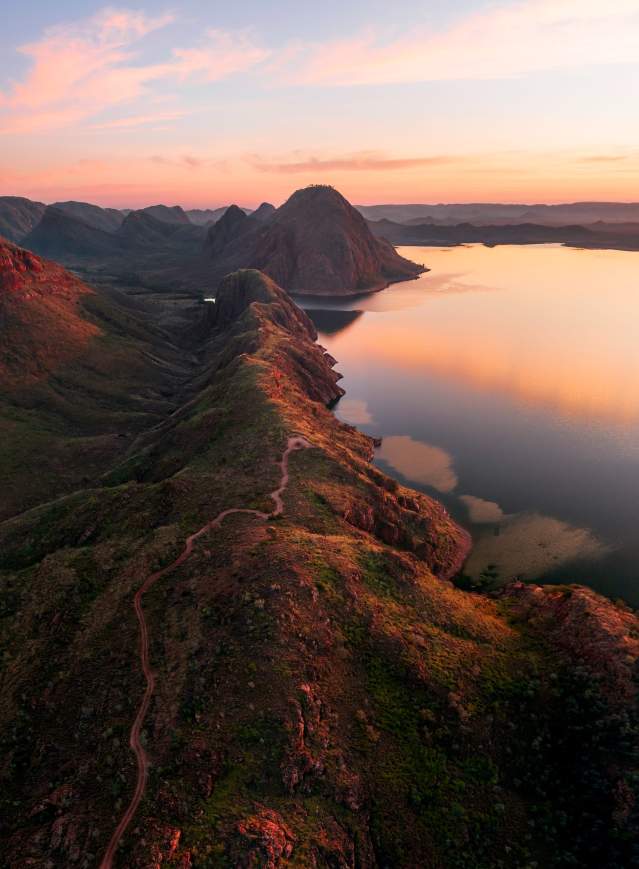 A drone view of a walking/mountain bike trail leading to an elevated lookout point at Lake Argyle