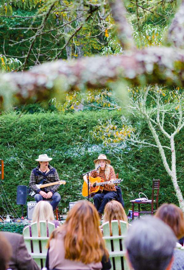 A group of people enjoying an intimate outdoor musical performance.