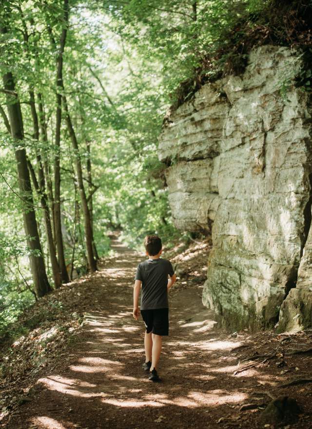 Young kid walking along the trail next to the Ledges at Fitzgerald Park