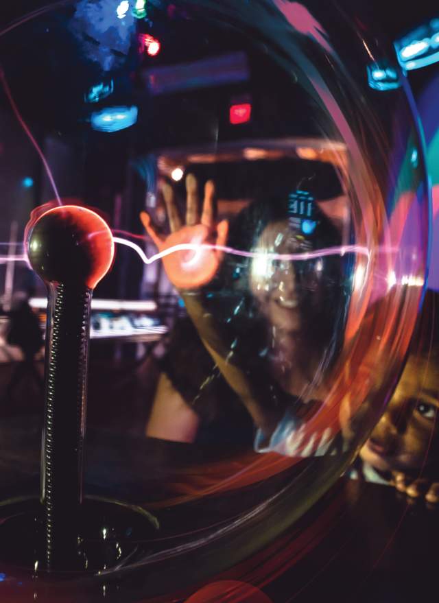 Child interacting with electromagnetic spectrum at Impression 5 Museum