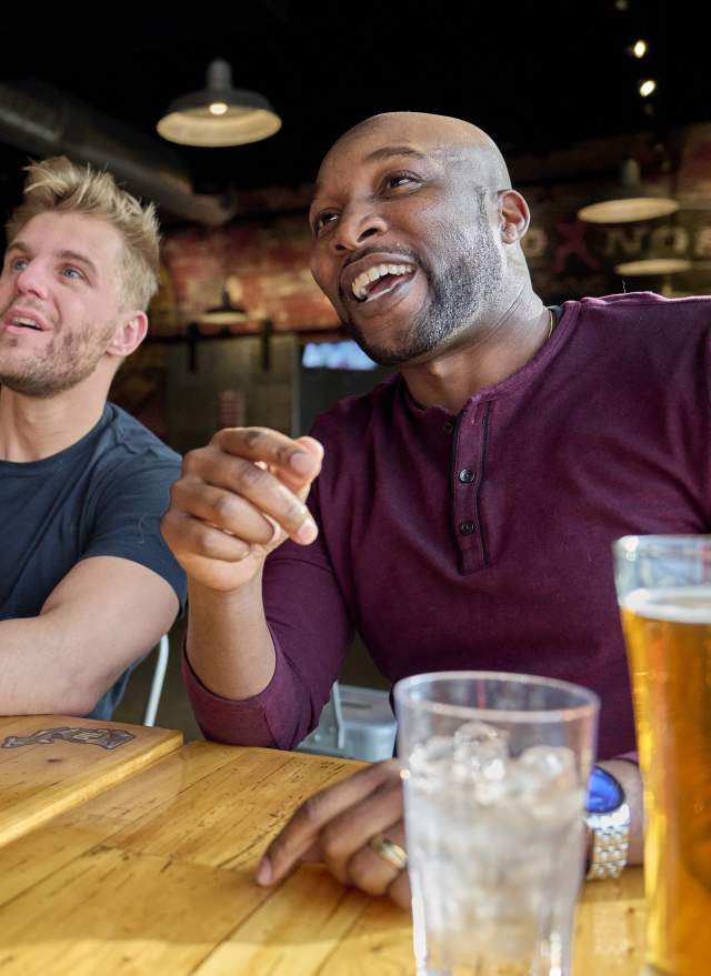 Two people watching the game at a bar