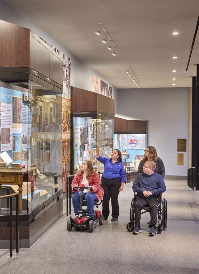 Wheelchair users getting a tour of Heritage Hall