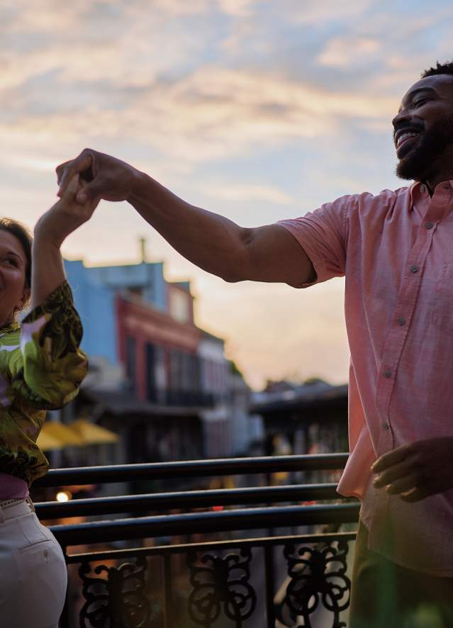 A couple dances on a French Quarter balcony