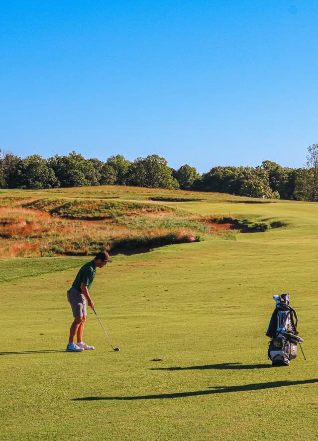 Two men playing golf at the Pfau Course