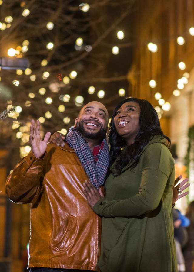 smiling couple in Larimer Square with lights