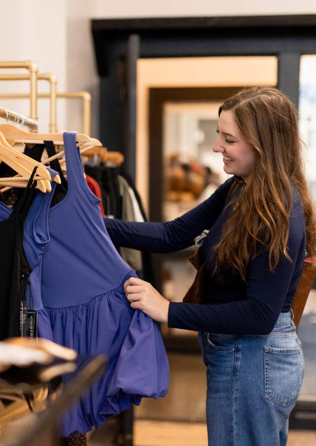 Shoppers browsing clothing and gifts inside Reedefined Boutique in Downtown Denison