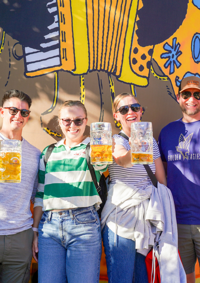5 friends holding up beer steins at TosaFest