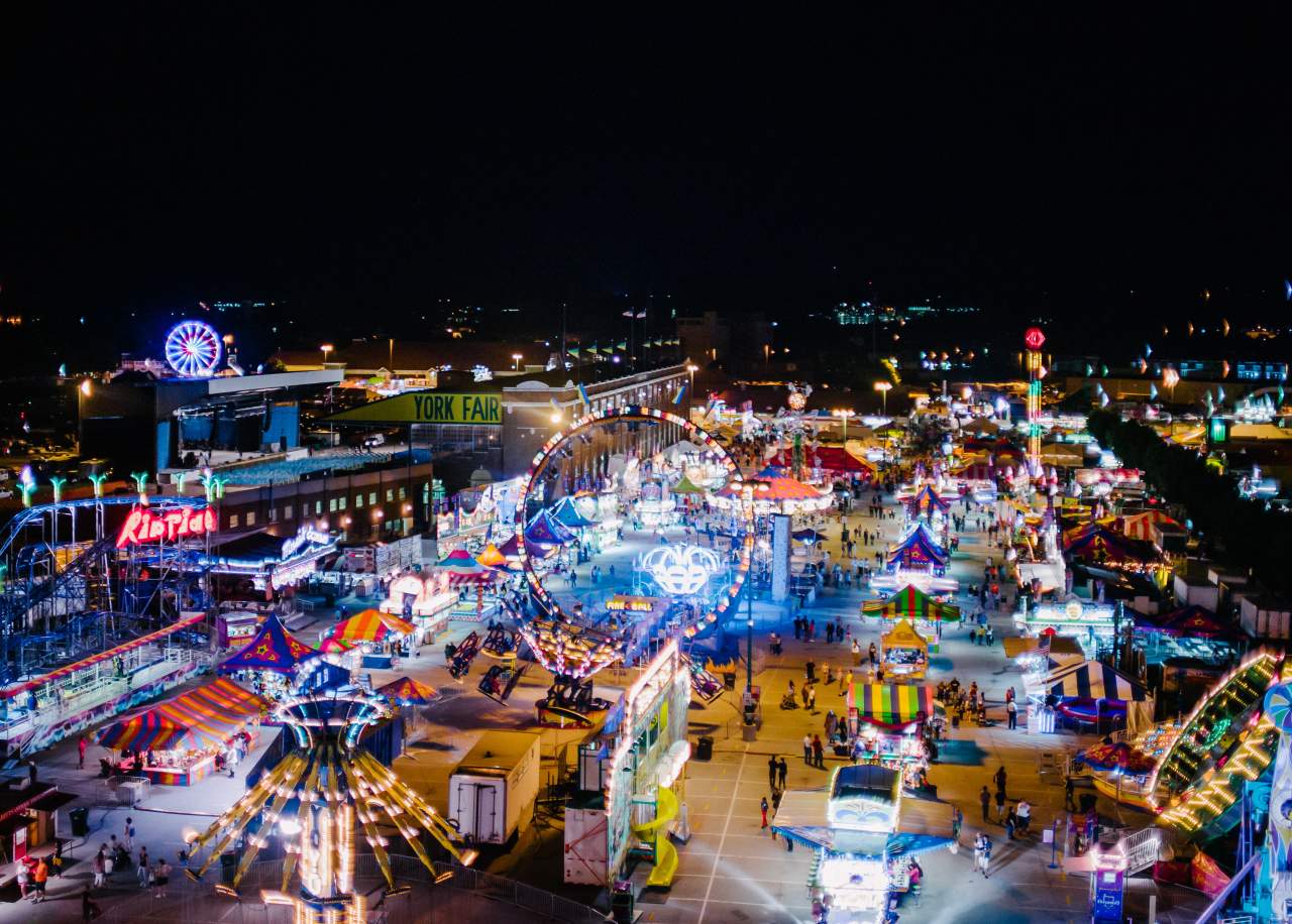 Aerial view of York State Fair at night with glowing rides