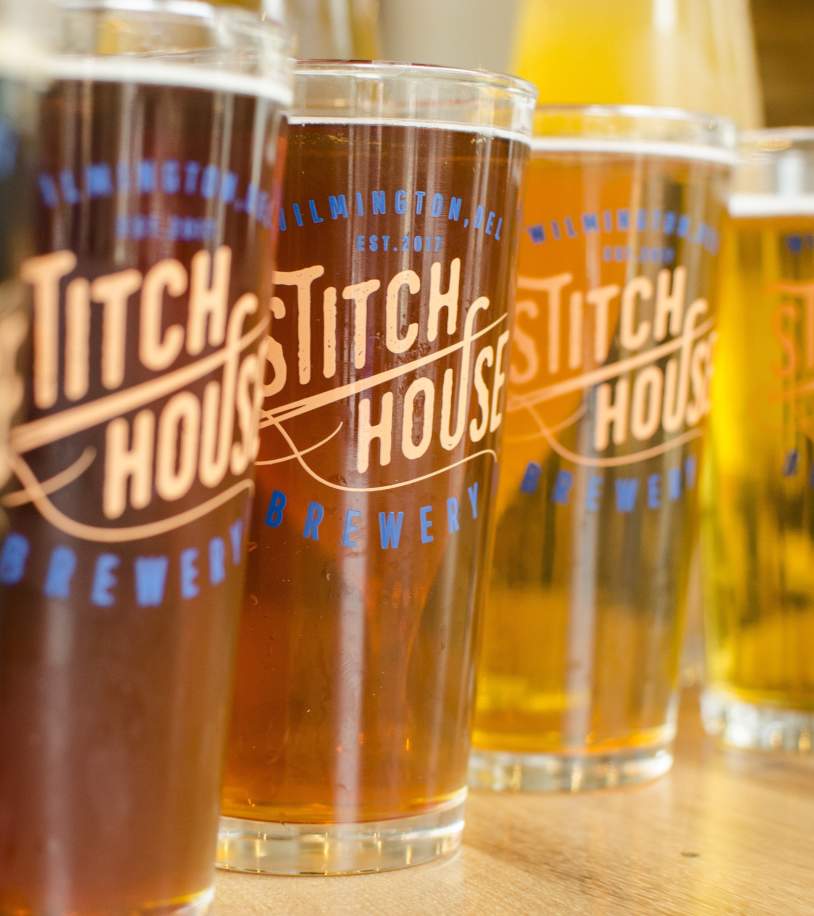 Stitch House Brewery beers in assorted amber and golden hues.