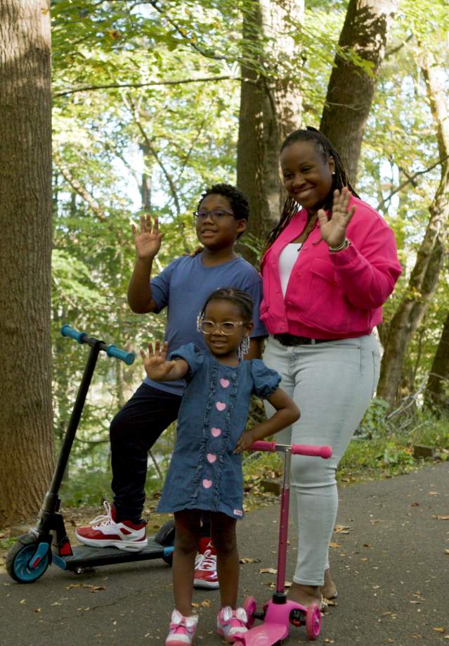 Family and kids on scooters on Clarksville Greenway
