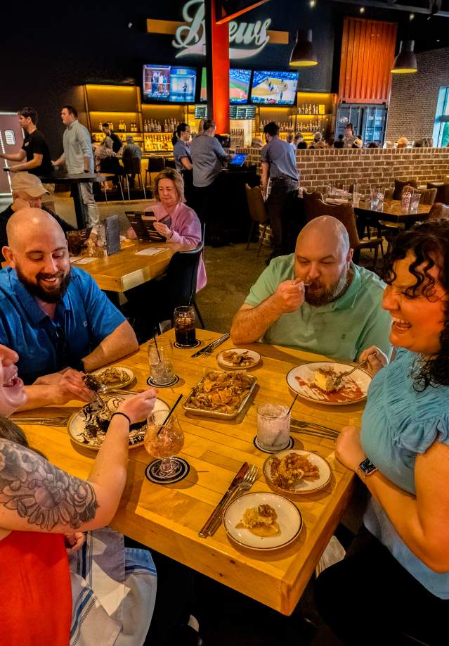 group of people enjoying food in a restaurant