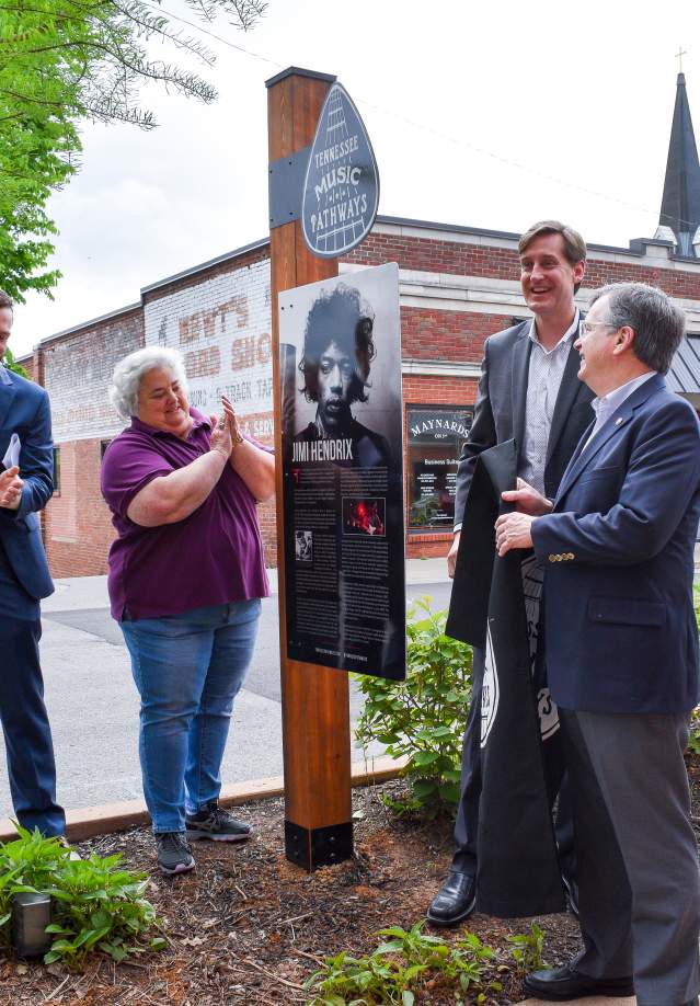 people clap around music marker honoring Jimi Hendrix