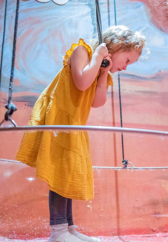 girl inside a large bubble maker